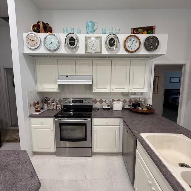 kitchen with backsplash, sink, white cabinetry, and stainless steel appliances