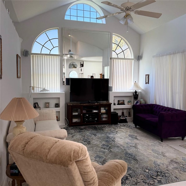 living room with ceiling fan and high vaulted ceiling