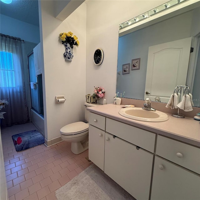 full bathroom featuring tile patterned flooring, vanity, toilet, and enclosed tub / shower combo