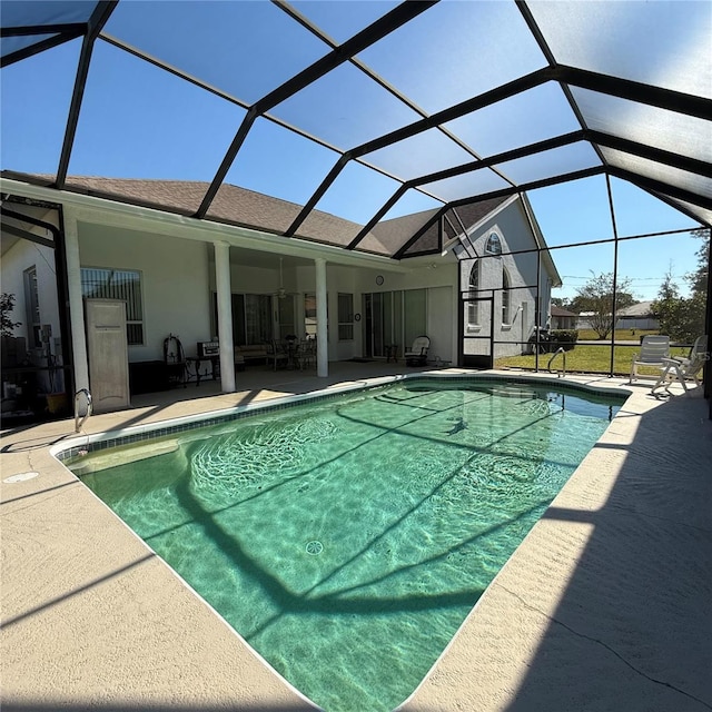 view of swimming pool with a patio and glass enclosure