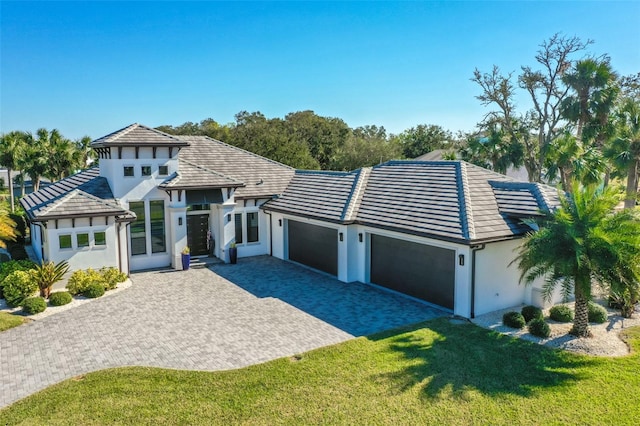 view of front of home featuring a garage and a front lawn