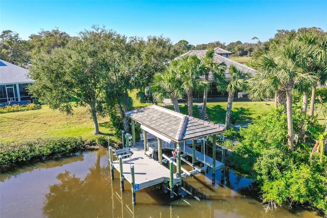 dock area with a water view and a lawn