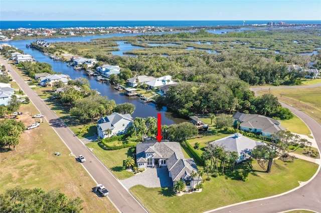 birds eye view of property with a water view