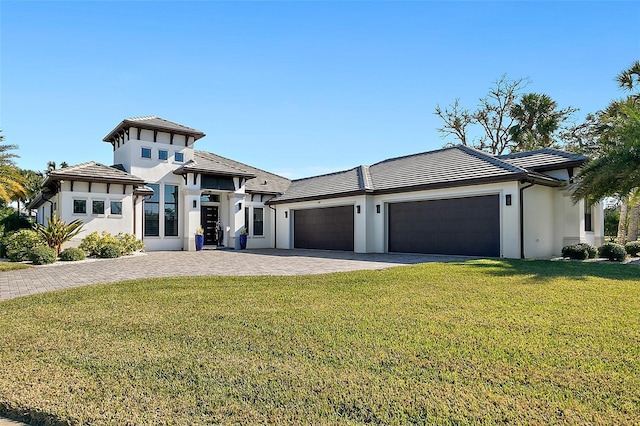 view of front of home with a garage and a front lawn