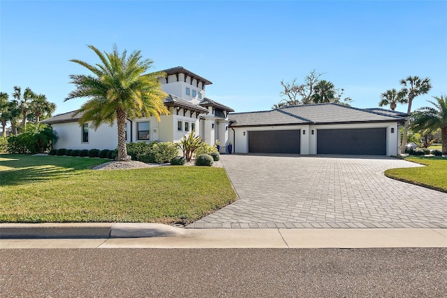 view of front facade with a garage and a front lawn