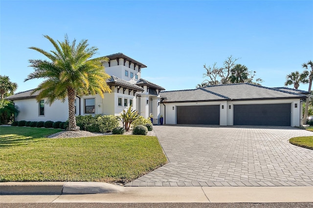 view of front of property with a front yard and a garage