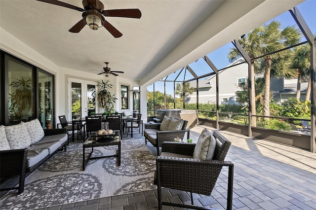 sunroom / solarium with ceiling fan, french doors, and a healthy amount of sunlight