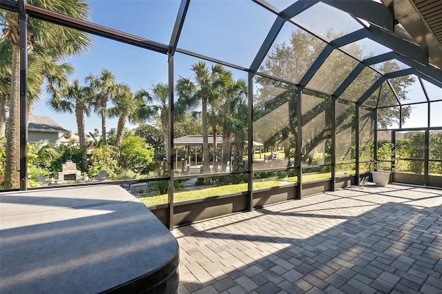 view of patio featuring glass enclosure