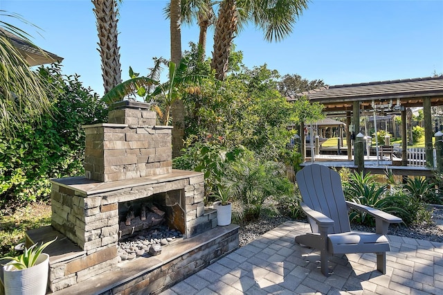 view of patio featuring an outdoor stone fireplace