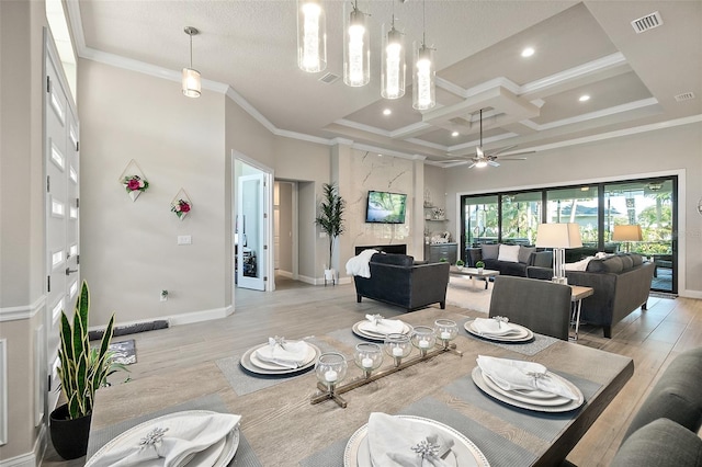 dining room featuring light hardwood / wood-style floors, crown molding, ceiling fan, and coffered ceiling