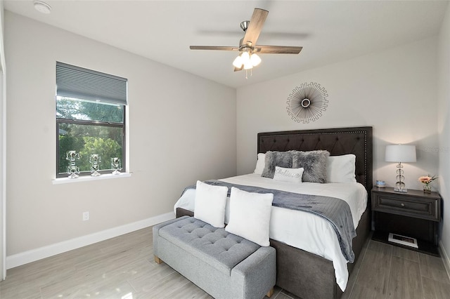 bedroom with wood-type flooring and ceiling fan