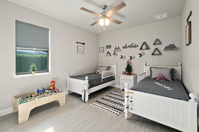 bedroom with hardwood / wood-style floors and ceiling fan