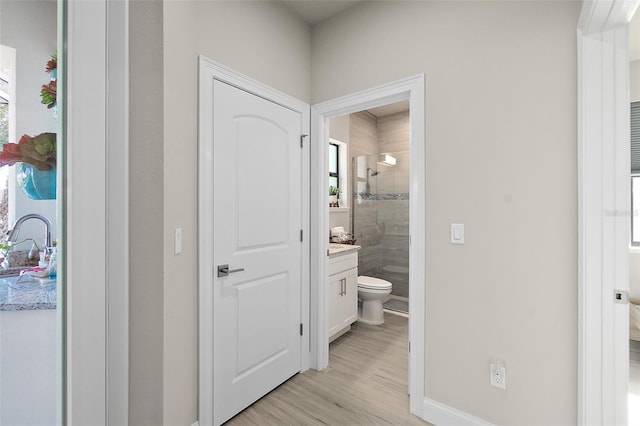 bathroom featuring hardwood / wood-style floors, vanity, toilet, and a shower with shower door