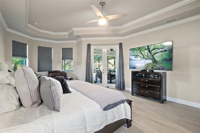 bedroom featuring access to exterior, ceiling fan, crown molding, a tray ceiling, and light wood-type flooring