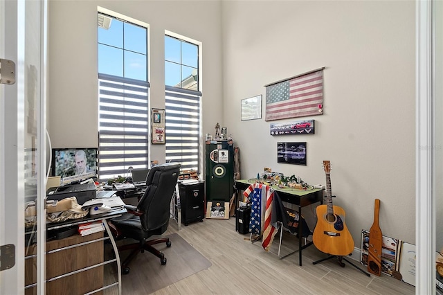 home office with light hardwood / wood-style flooring