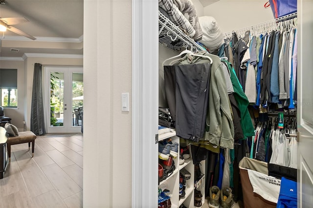 walk in closet featuring ceiling fan