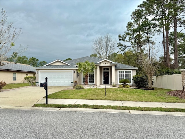 view of front of house featuring a front yard, fence, stucco siding, concrete driveway, and a garage