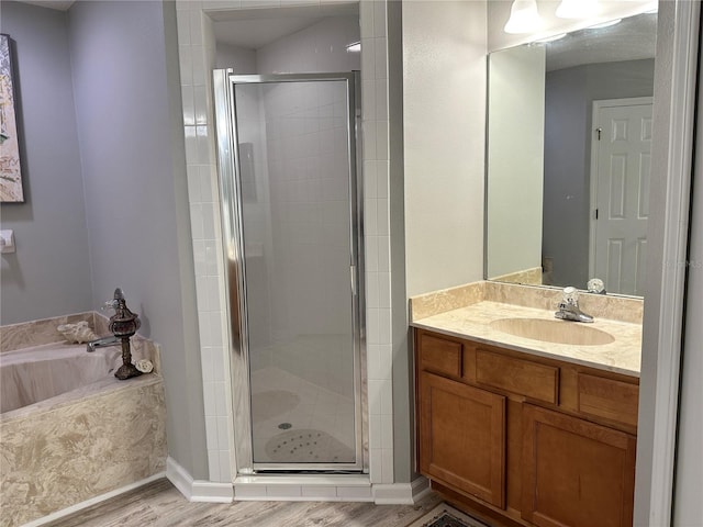 full bathroom with vanity, wood finished floors, a shower stall, and a bath