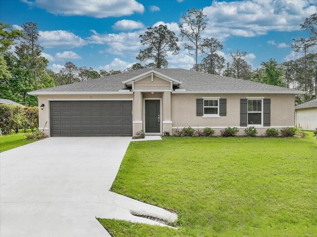 single story home featuring a garage and a front lawn