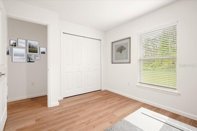 bedroom featuring light wood-type flooring and a closet