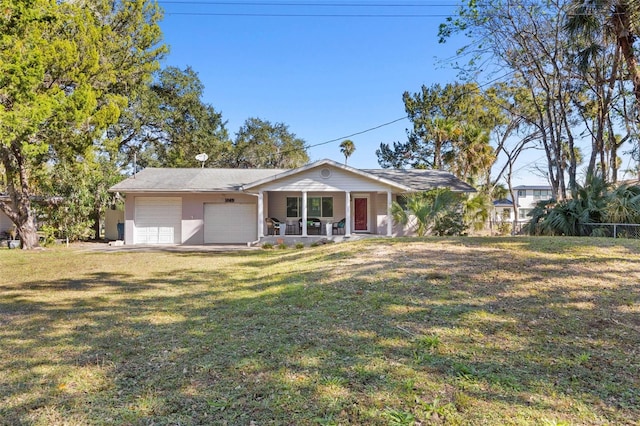 single story home with covered porch, a garage, and a front lawn