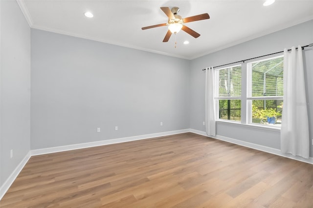 empty room featuring light hardwood / wood-style floors, ceiling fan, and crown molding