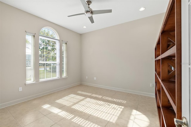 unfurnished room with ceiling fan and light tile patterned flooring