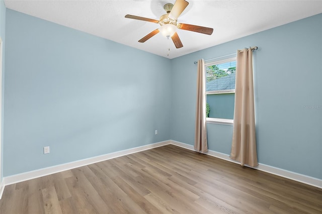 spare room with light hardwood / wood-style flooring and ceiling fan