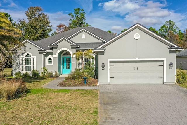 ranch-style house featuring a front yard and a garage