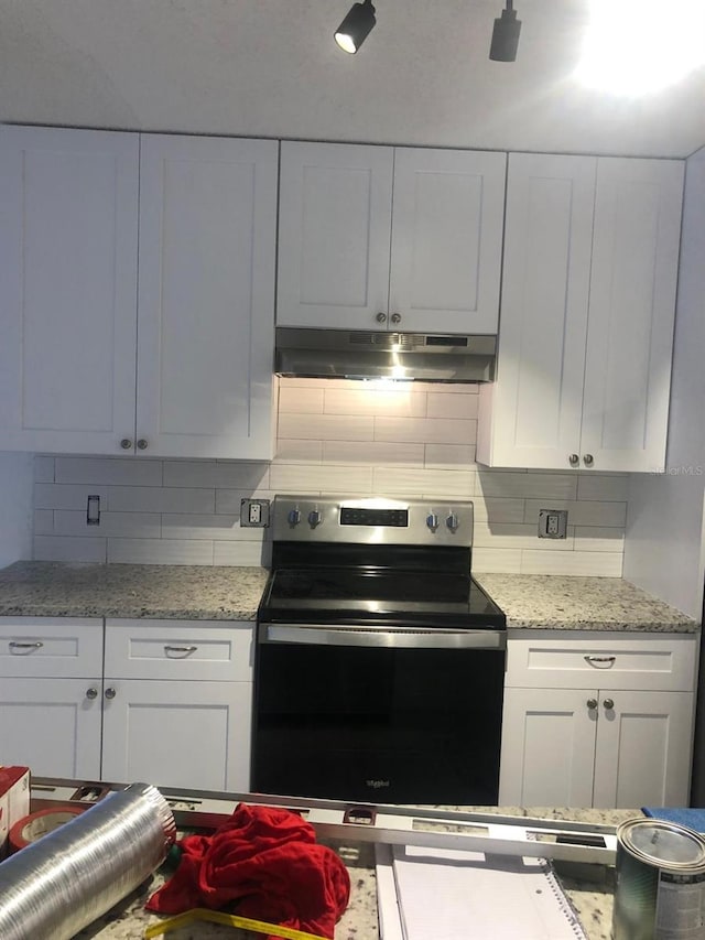 kitchen featuring white cabinetry, light stone countertops, decorative backsplash, and electric stove