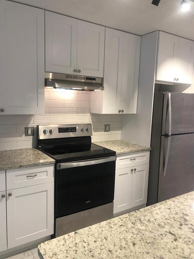 kitchen featuring white cabinets, appliances with stainless steel finishes, and tasteful backsplash