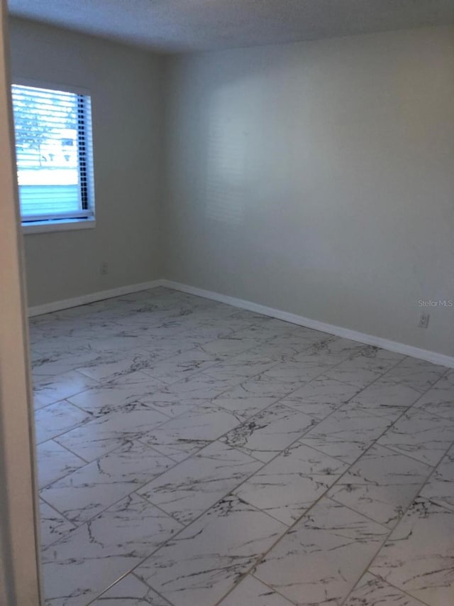 empty room featuring a textured ceiling