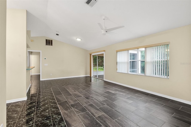 empty room featuring ceiling fan, dark wood-type flooring, and vaulted ceiling