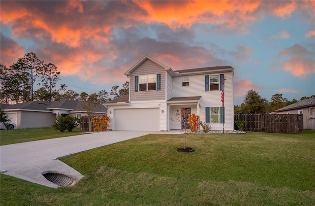 view of front property with a yard and a garage