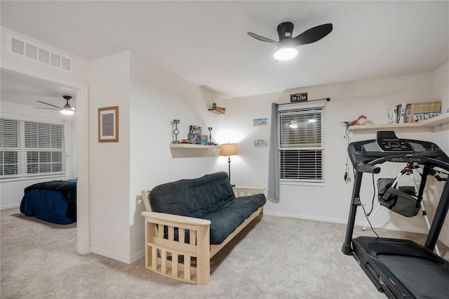 exercise area with light carpet and ceiling fan