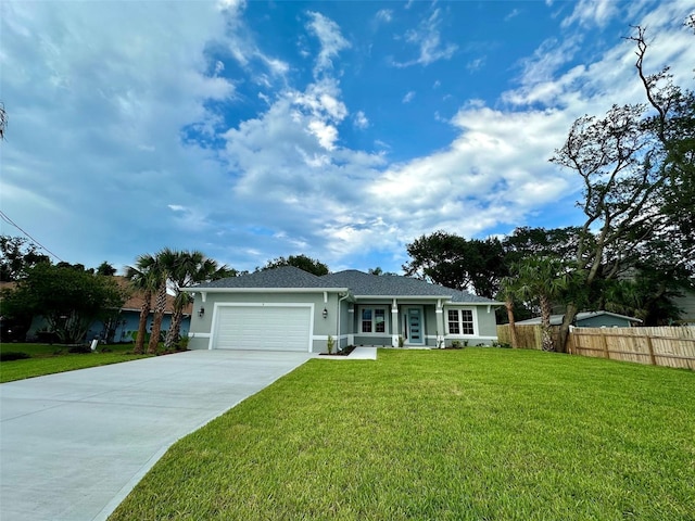 ranch-style house featuring a front lawn and a garage