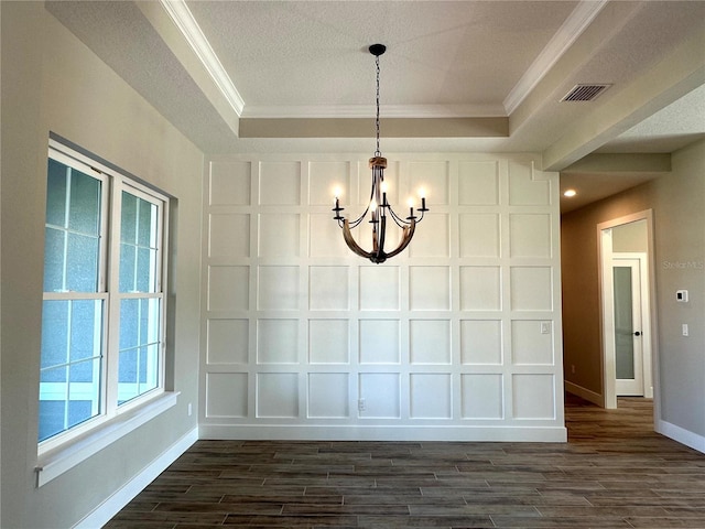 unfurnished dining area featuring a raised ceiling, crown molding, and dark hardwood / wood-style floors