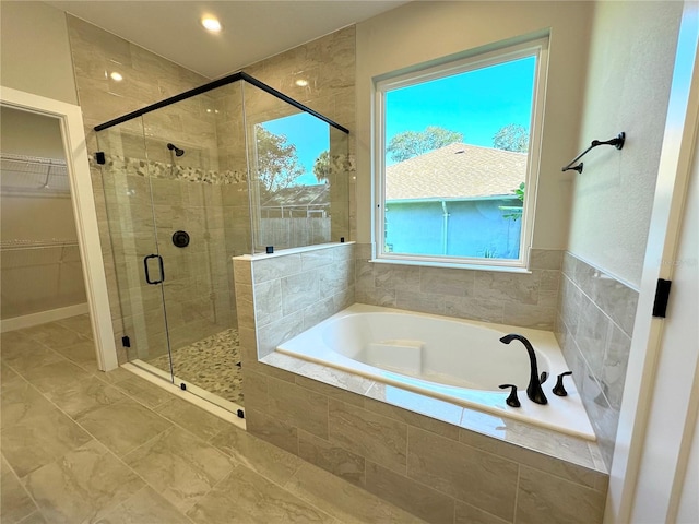 bathroom with plus walk in shower and a wealth of natural light