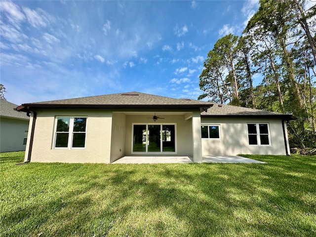 back of house featuring a patio, stucco siding, a ceiling fan, and a lawn