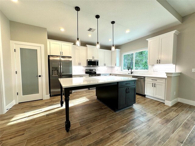6 Lake Pl, Palm Coast, FL 32137 - kitchen featuring stainless steel appliances, a center island, white cabinetry, light countertops, and recessed lighting