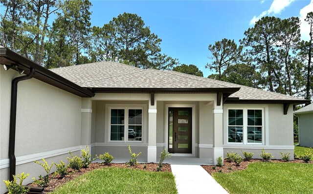 6 Lake Pl, Palm Coast, FL 32137 - doorway to property featuring a shingled roof, stucco siding, and a yard