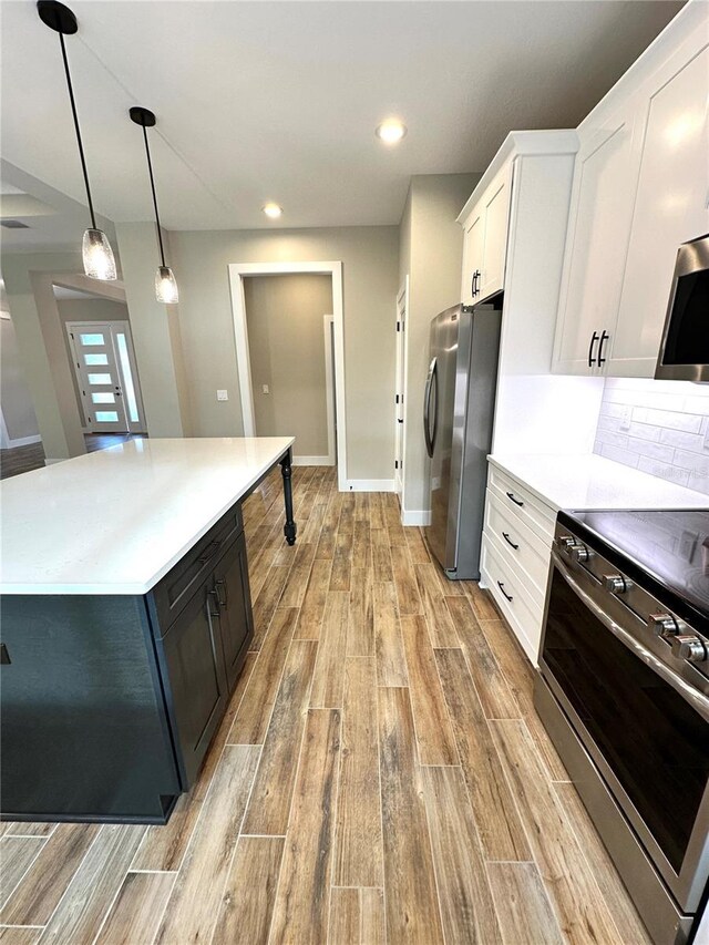 6 Lake Pl, Palm Coast, FL 32137 - kitchen with appliances with stainless steel finishes, light wood finished floors, white cabinets, light countertops, and recessed lighting
