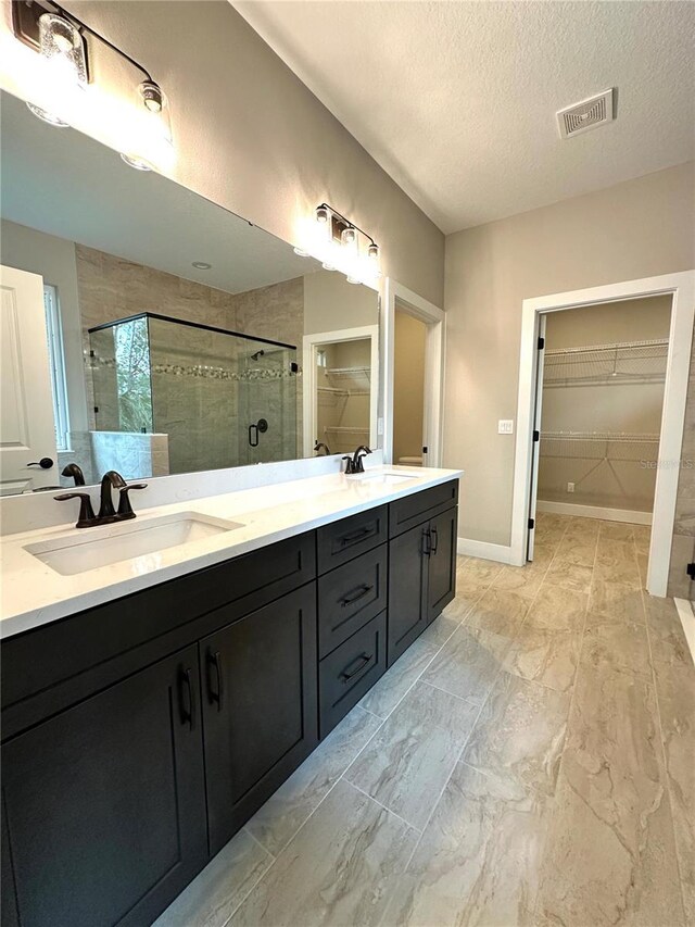 6 Lake Pl, Palm Coast, FL 32137 - full bath featuring a spacious closet, a shower stall, double vanity, a textured ceiling, and marble finish floors
