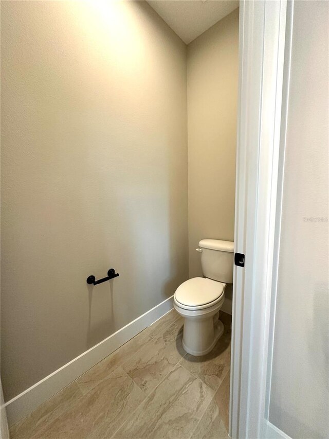 6 Lake Pl, Palm Coast, FL 32137 - bathroom featuring toilet and baseboards