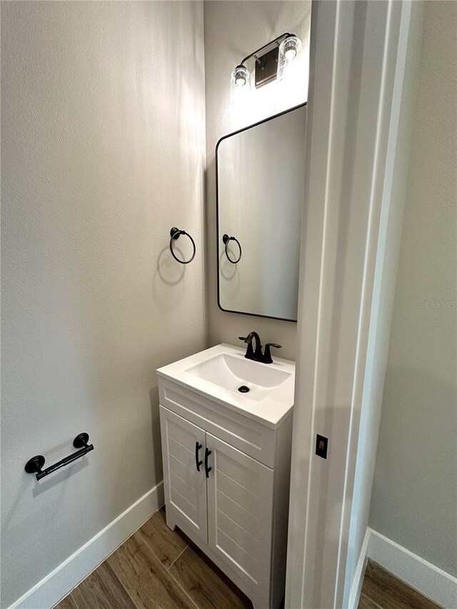 6 Lake Pl, Palm Coast, FL 32137 - bathroom featuring wood finished floors, baseboards, and vanity