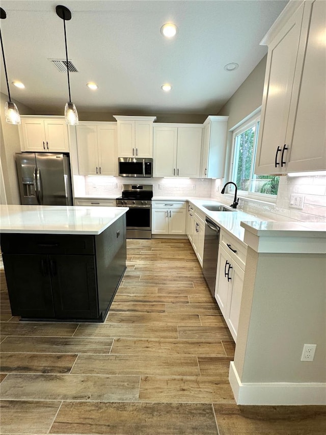 6 Lake Pl, Palm Coast, FL 32137 - kitchen featuring appliances with stainless steel finishes, a sink, light countertops, a kitchen island, and recessed lighting