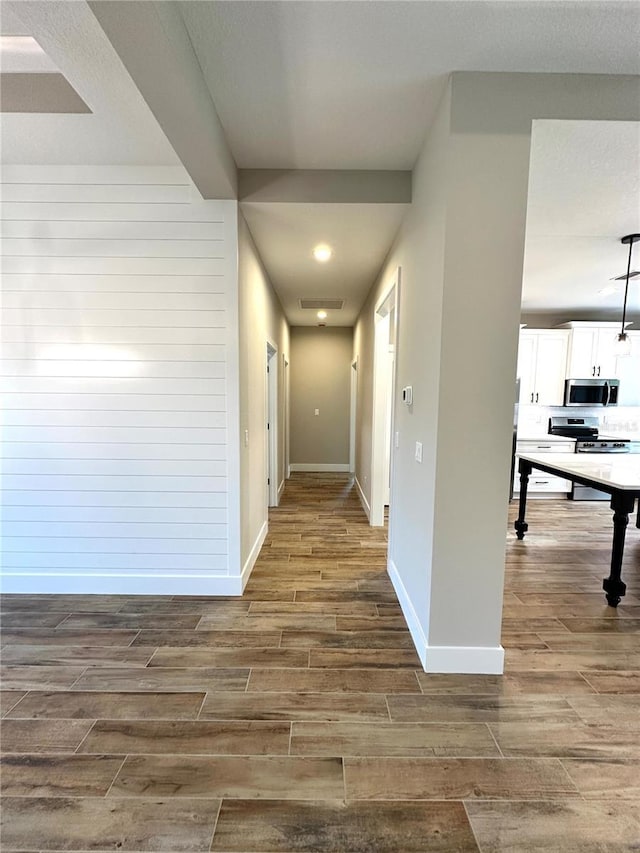 6 Lake Pl, Palm Coast, FL 32137 - hall with wood finished floors, baseboards, recessed lighting, and wood walls