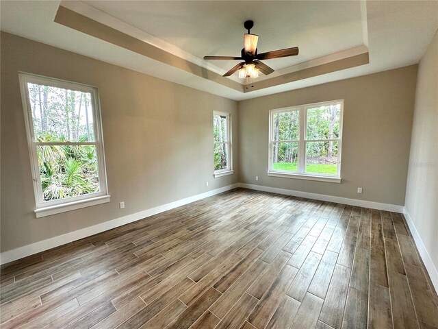 6 Lake Pl, Palm Coast, FL 32137 - spare room featuring a raised ceiling, wood finished floors, baseboards, and ceiling fan