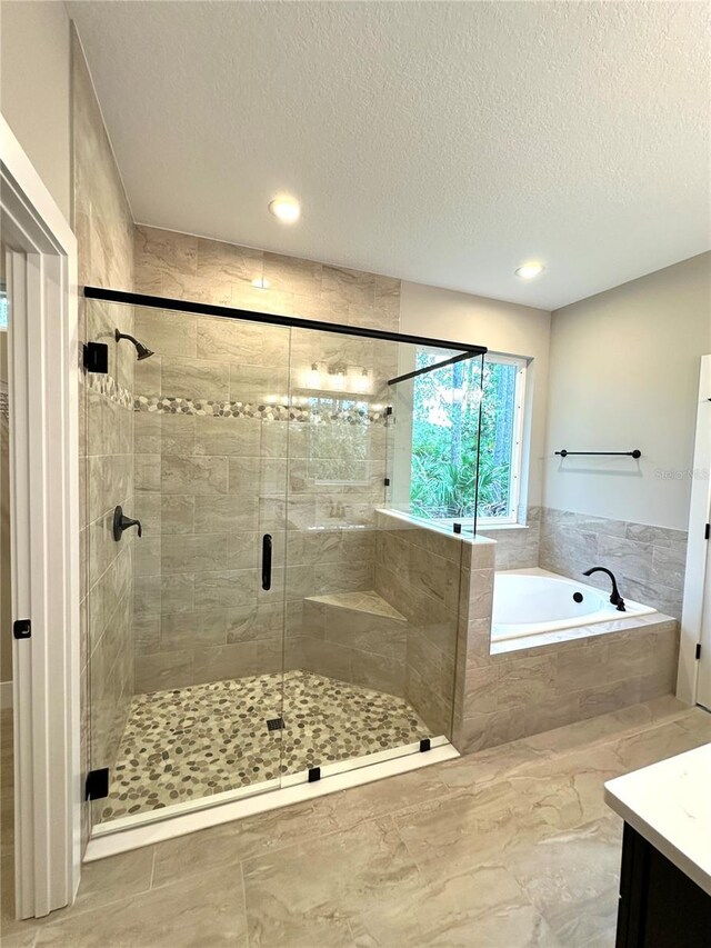 6 Lake Pl, Palm Coast, FL 32137 - bathroom featuring a garden tub, a shower stall, a textured ceiling, vanity, and recessed lighting