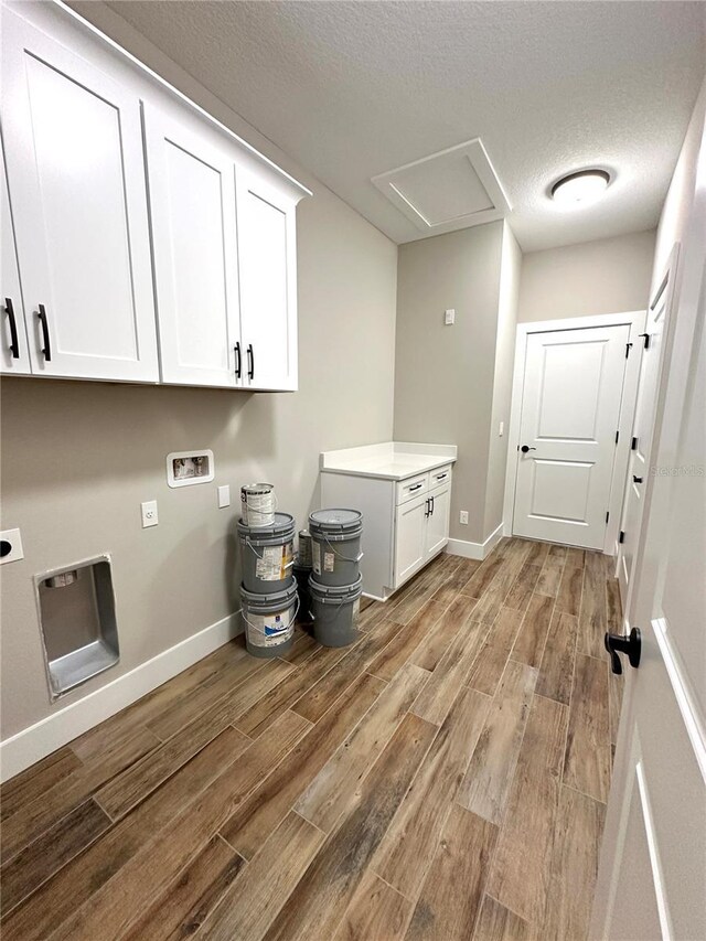 6 Lake Pl, Palm Coast, FL 32137 - laundry room with cabinet space, light wood-type flooring, hookup for an electric dryer, baseboards, and a textured ceiling